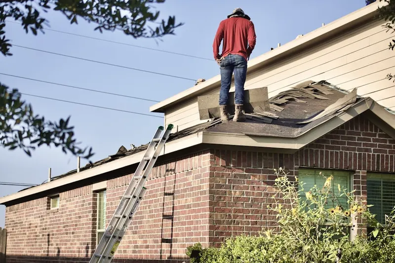 Professional roofer working on a residential roof in Harrison